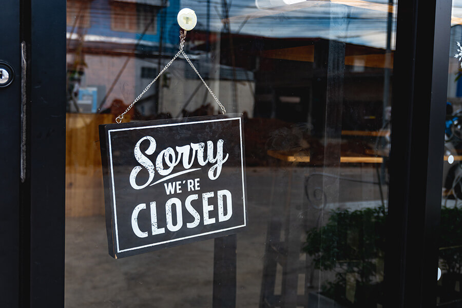 A photo of a closed sign in a shop window